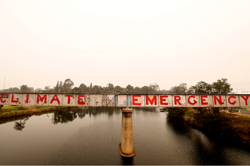 Graffiti reading 'climate emergency' is seen on a bridge on 3 January 2020 in Bairnsdale, Vic. (Photo by Darrian Traynor/Getty Images)