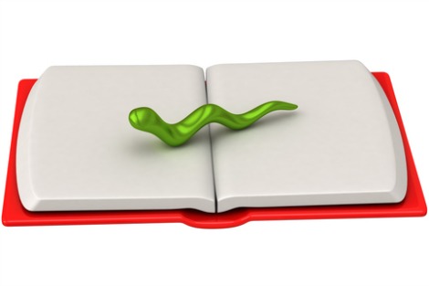 Green bookworm on open blank book