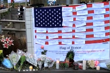 Flowers and a 'flag of honour' for those who died in the Sandy Hook shootings