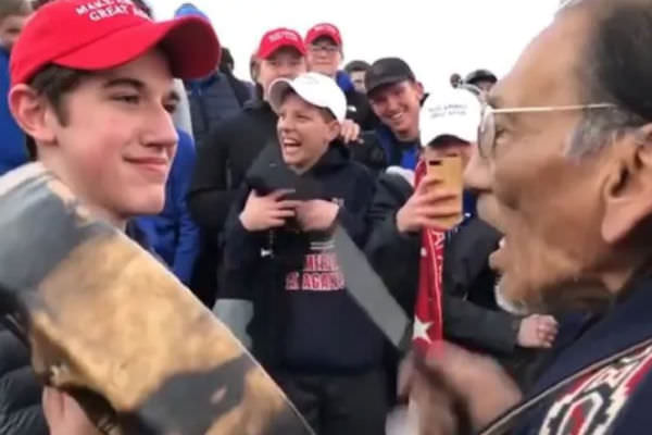 Nick Sandmann, left, faces Native American elder Nathan Phillips.