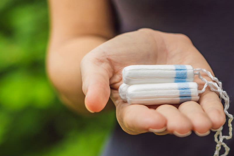 Woman's hand holding tampons (Getty Creative)