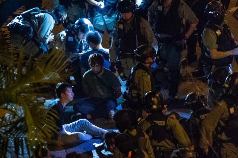 Police detain protesters and students after they tried to flee outside the Hong Kong Polytechnic University campus in the Hung Hom district on 19 November 2019. (Photo by Billy H.C. Kwok/Getty Images)