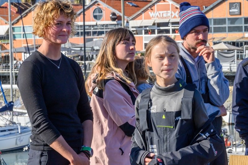 Swedish teen climate activist Greta Thunberg (front) stands with British professional yachtswoman Nicola Henderson and yacht owners Elayna Carausu and Riley Whitelum at Santo Amaro Recreation dock in Lisbon, Portugal, on 3 December 2019. Thunberg sailed from Norfolk, Virginia, USA on the catamaran La Vagabonde on her way to attend COP25 in Madrid, Spain. (Photo by Horacio Villalobos/Getty Images)