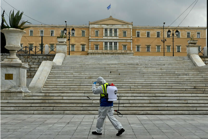 A municipal worker disinfects Syntagma square on March 23, 2020 in Athens, Greece. (Getty Images/ Milos Bicanski)