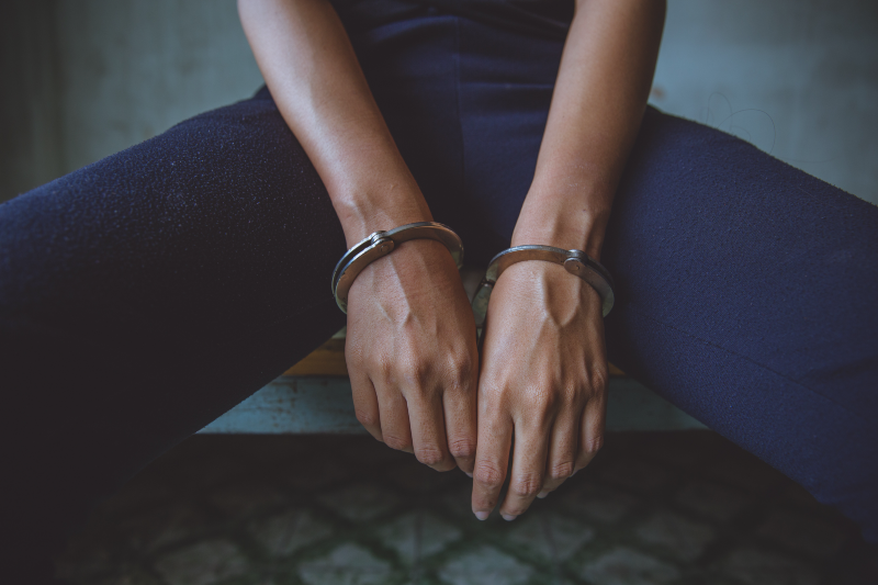 Woman wearing handcuffs (Nichcha Sombutpanich/Getty Images)