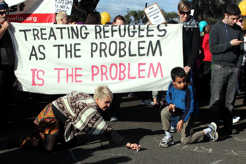 Refugee protest. Sign: 'Treating refugees as the problem is the problem.' (John Englart/Flickr)