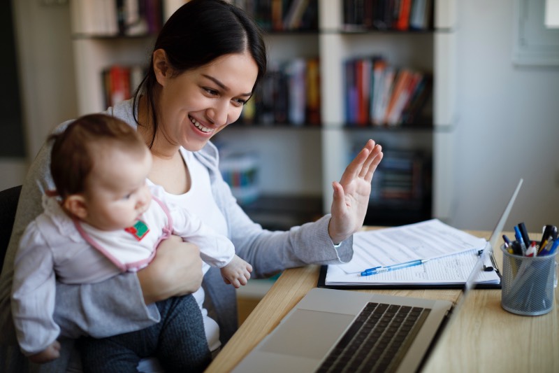 Woman videoconferencing with baby on her lap (damircudic/Getty Images)