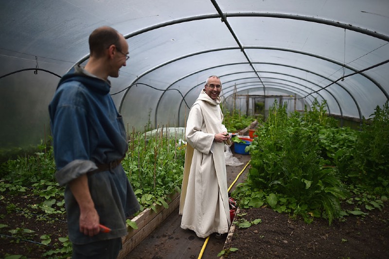 Main image: Benedictine monks work in a garden at Pluscarden Abbey (Jeff J Mitchell/Getty Images)