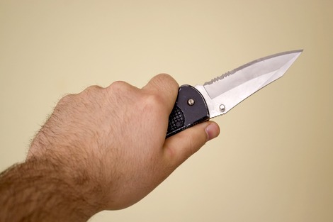 Hand holding a short knife