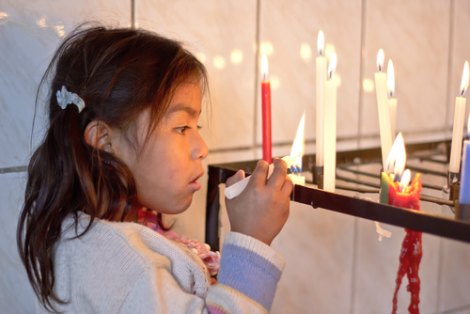 Girl lighting a candle