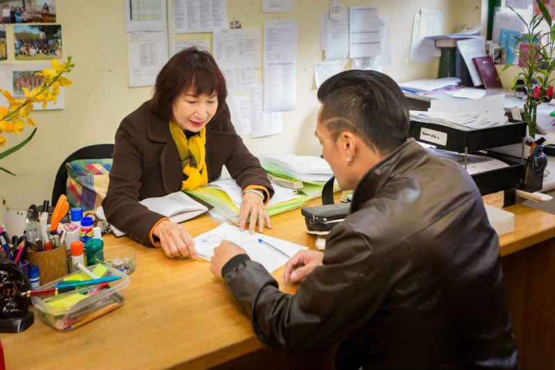 Jesuit Social Services staff member works with a client of one of the organisation's settlement programs.