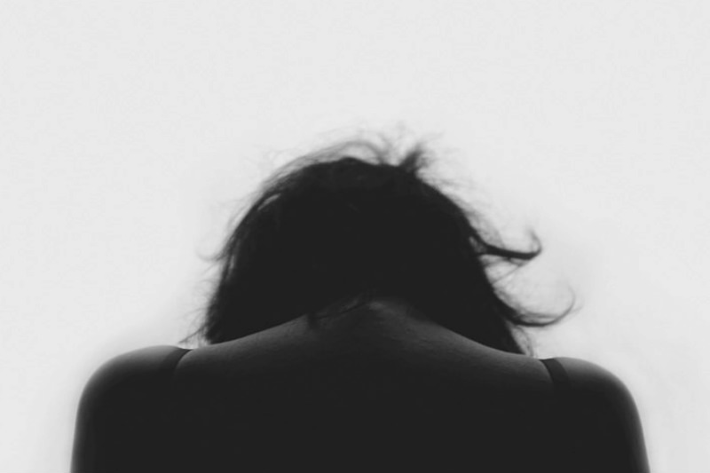 Silhouette of woman with slumped head