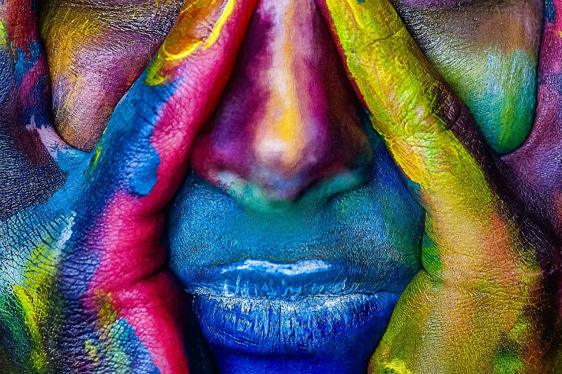 Face with multi-coloured paint