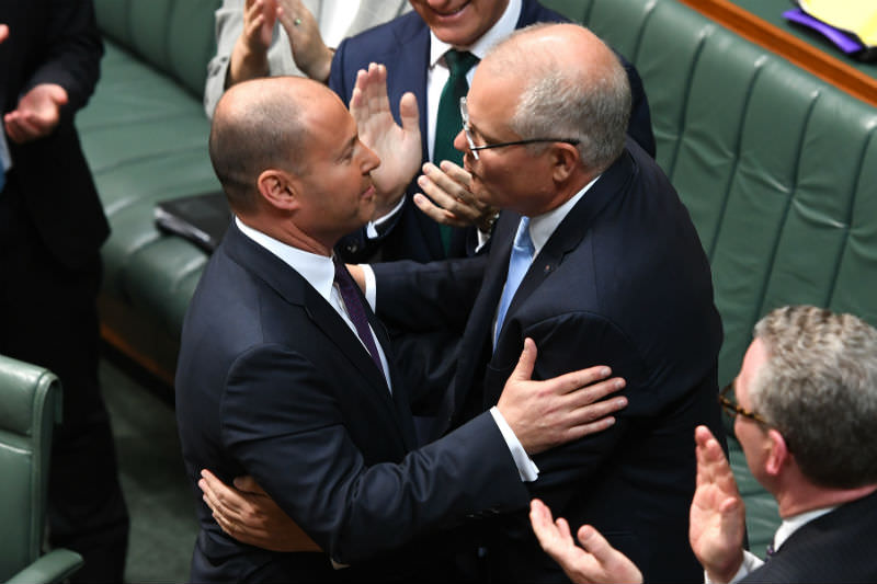 Treasurer Josh Frydenberg is congratulated by Prime Minister Scott Morrison after delivering the budget in the House of Representatives. (Photo by Tracey Nearmy/Getty Images)