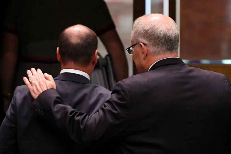 Prime Minister Scott Morrison (right) puts his arm around Treasurer Josh Frydenberg after Question Time in the House of Representatives at Parliament House on 13 February 2019. (Photo by Tracey Nearmy/Getty Images)