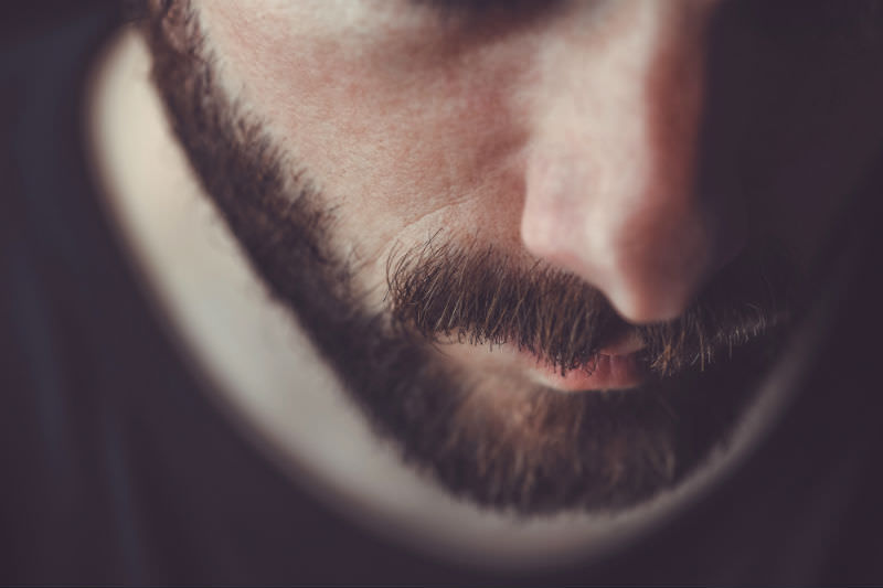 Closeup of a sad looking bearded man. Photo by Bojanikus via Getty