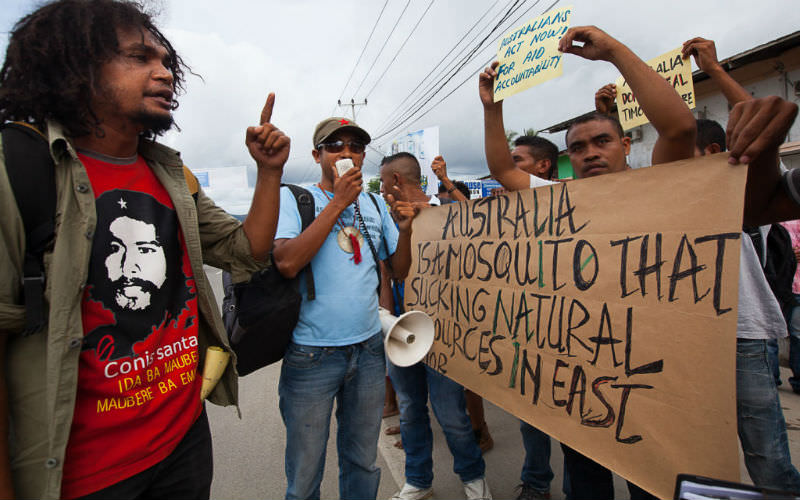 Protesters hold up signs during Anti-Australia protests on December 6, 2013 in Dili, Timor-Leste.