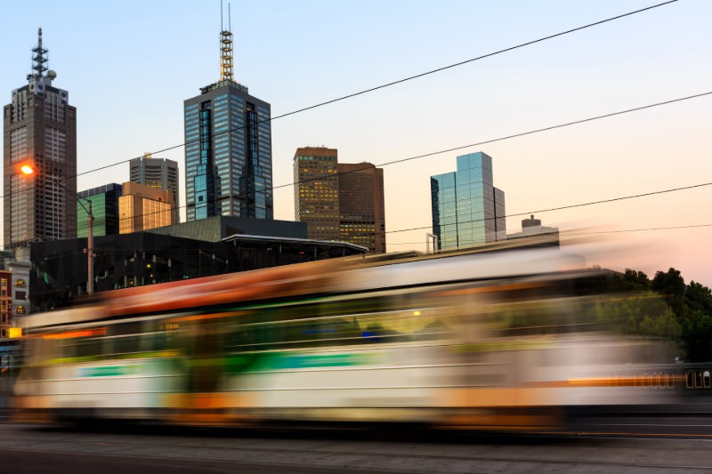 A tram in motion in Melbourne. (Credit: Onfokus / Getty)