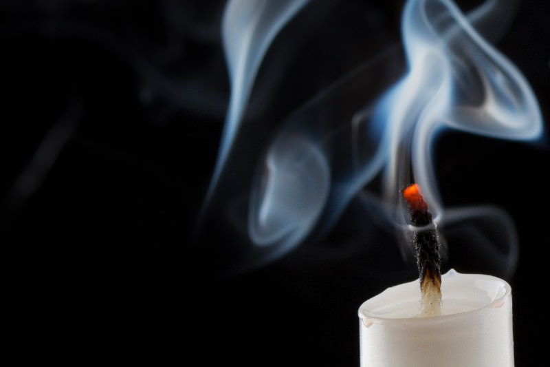 Swirling smoke from extinguished candle on black background (Credit: neamov / Getty)