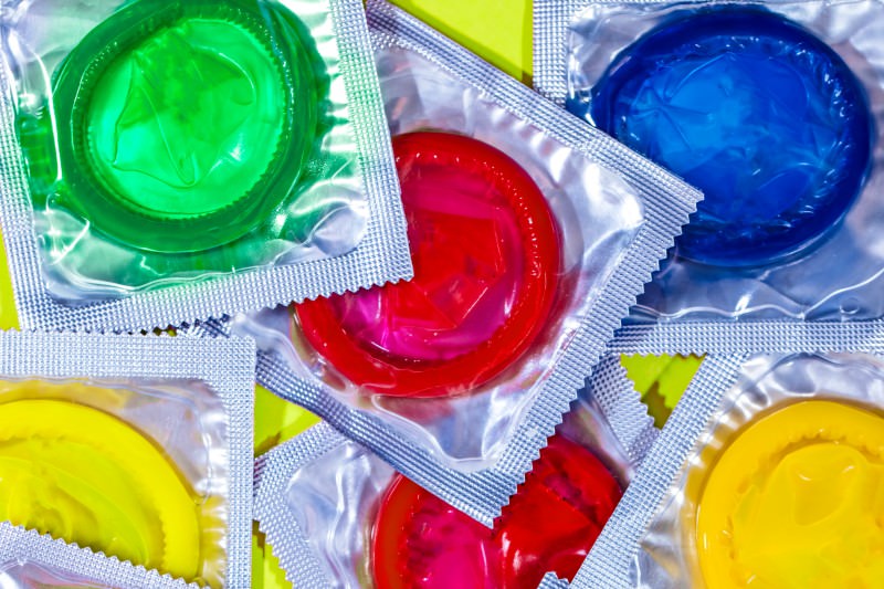 Packets of various coloured condoms (Credit: mikroman6 / Getty)